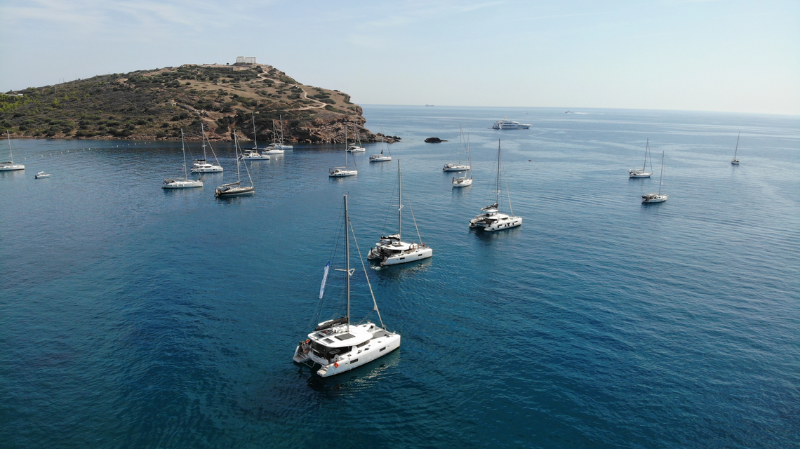 Bay off Rhodes with sailing yachts overlooking the Acropolis of Lindos
